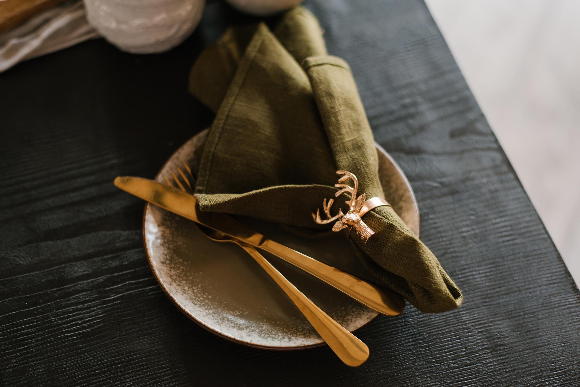 Intimate dining table with gold cutlery and linen