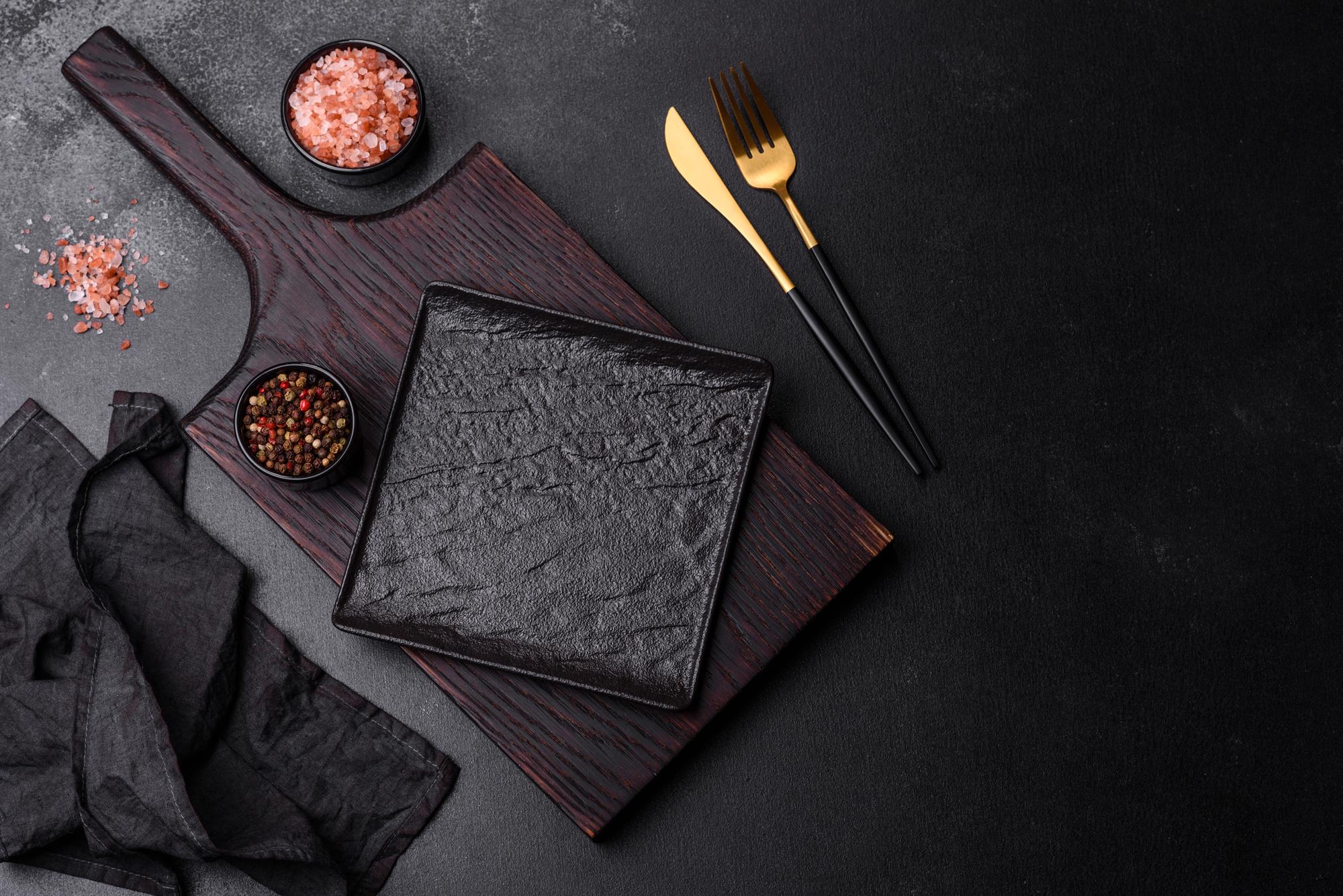 Overhead of a plated multi-course tasting menu on black slate